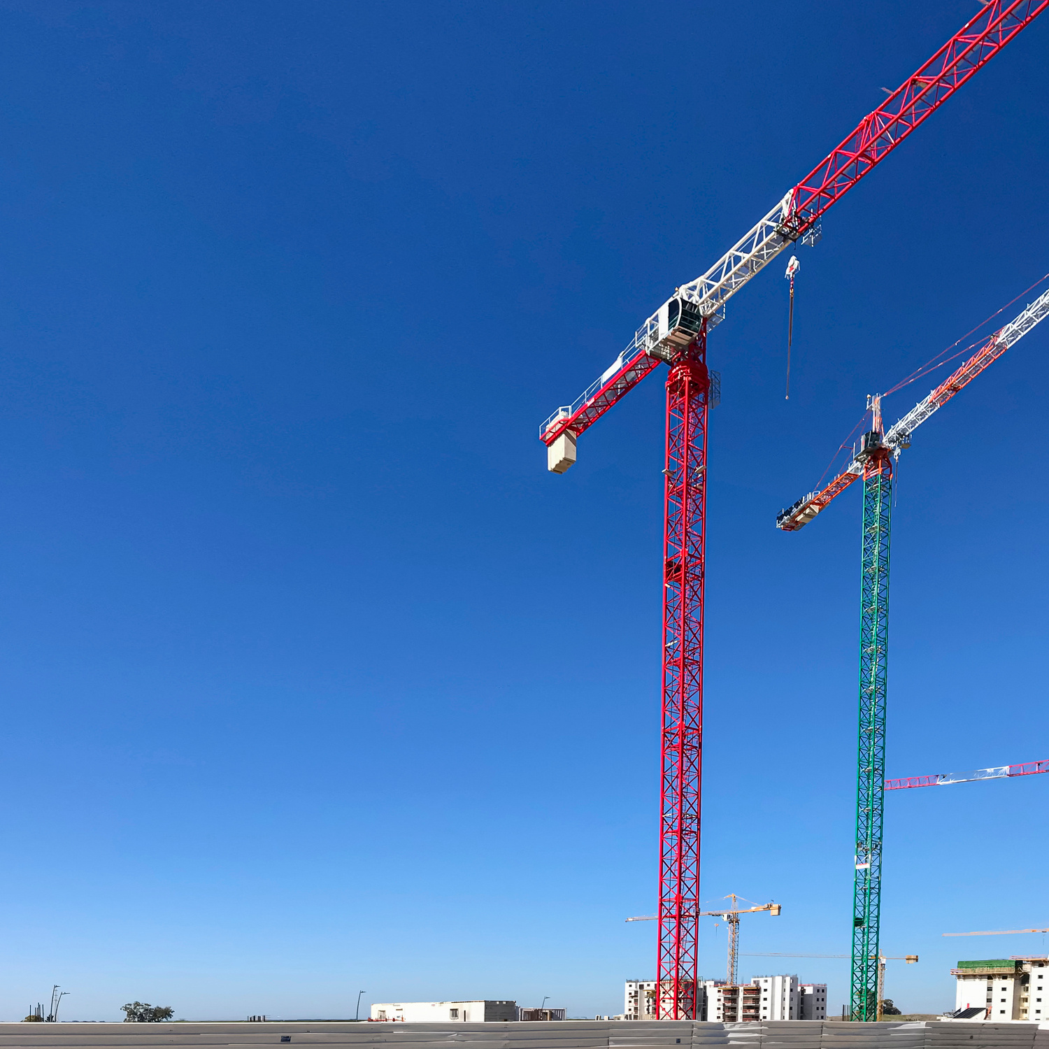 Constraction Cranes on the  Blue Sky Background